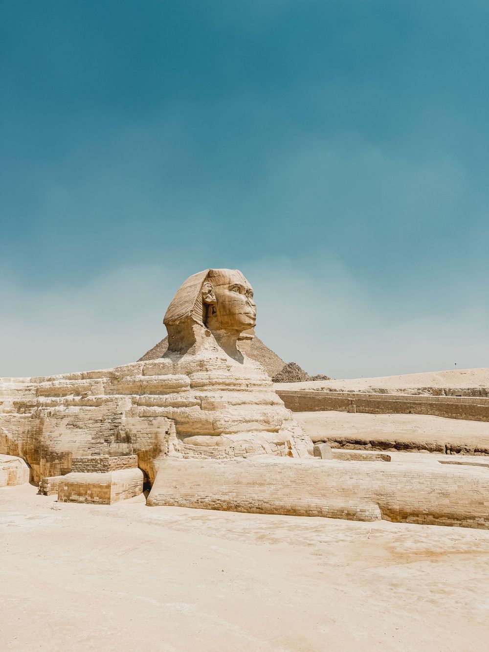 Panoramic sequence showing the ancient Great Sphinx of Giza at different angles against a turquoise desert sky.