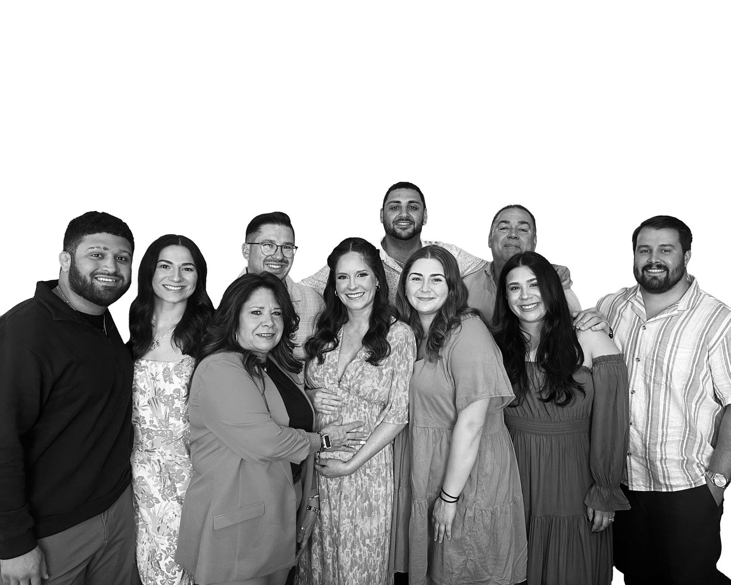 A group of people wearing casual attire posed together for a black and white portrait.