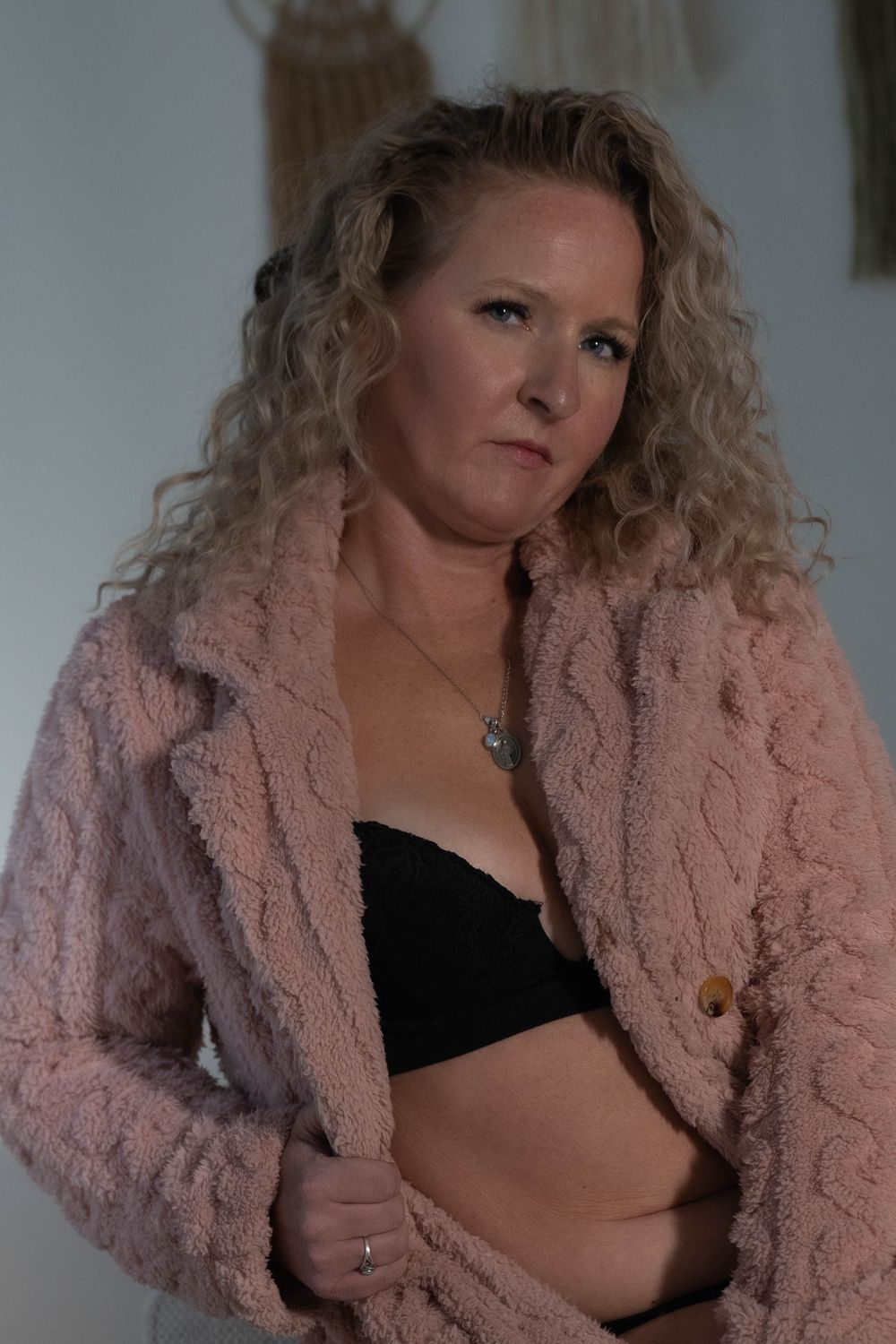 Intimate portrait series featuring a cozy pink fuzzy jacket.