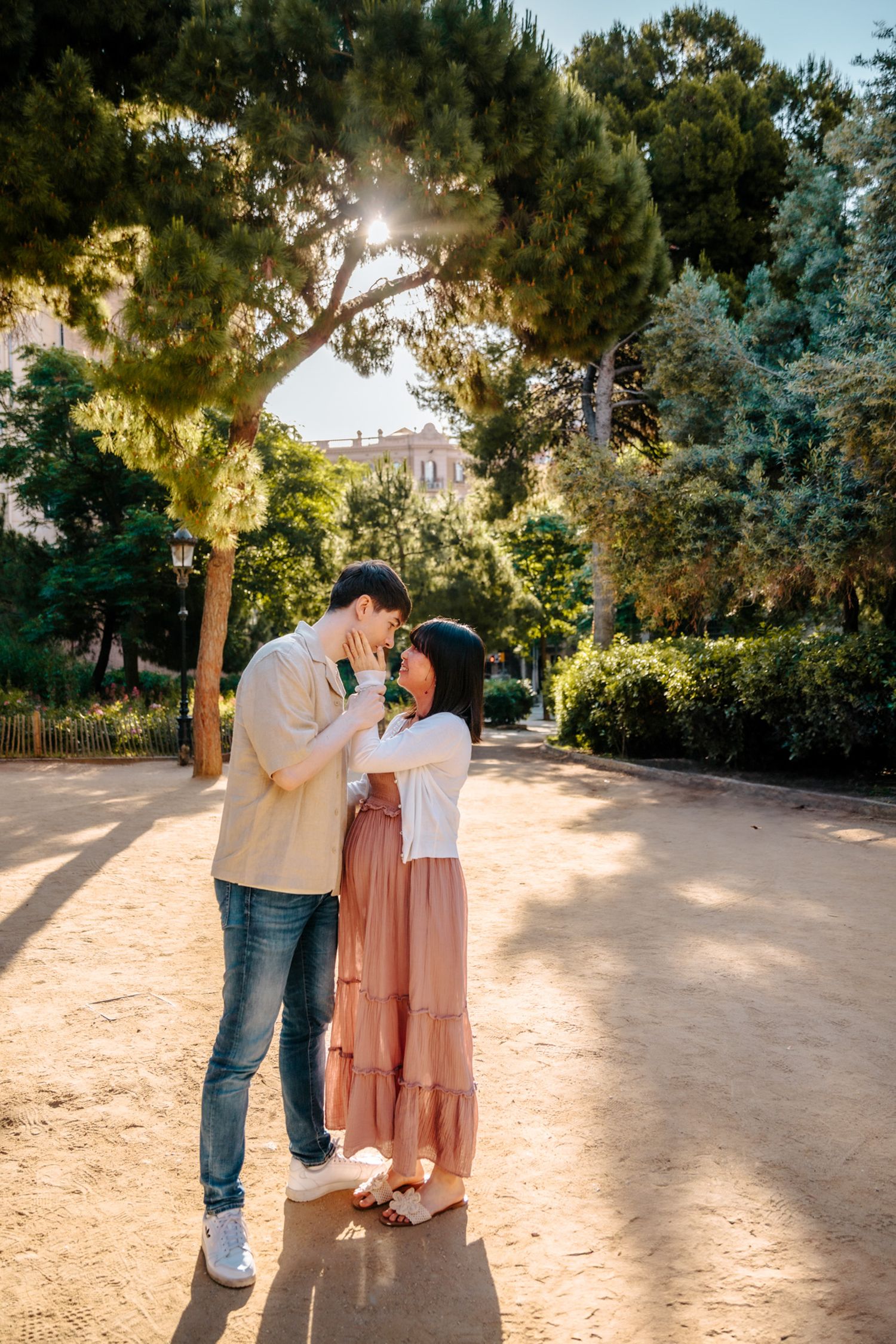 Couple posing together with love in front of Sagrada Familia’s intricate façade.