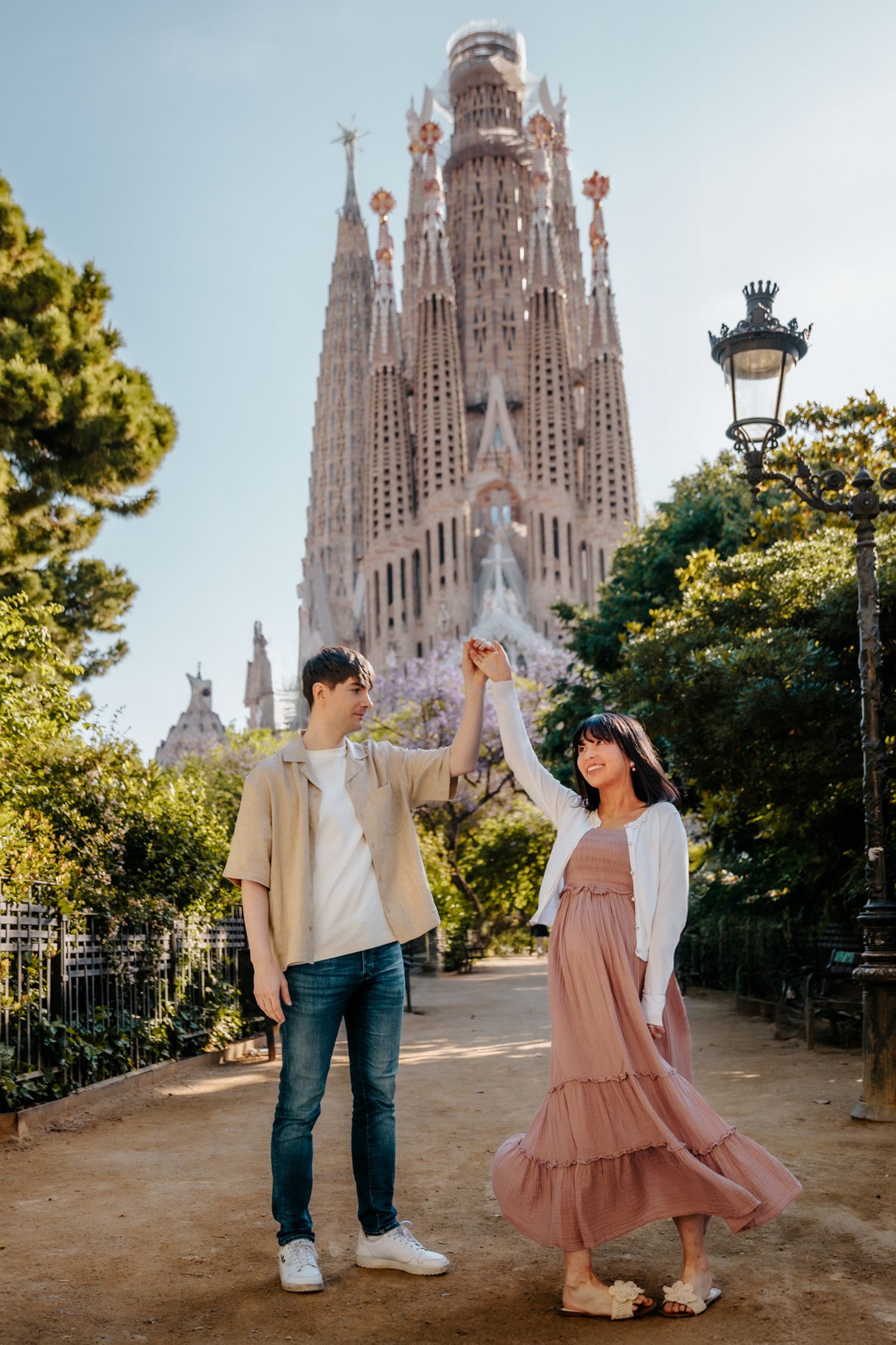 Romantic couple maternity photoshoot with iconic Barcelona views at Sagrada Familia.