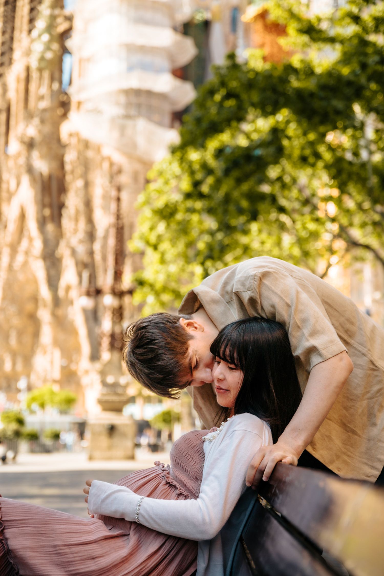 Romantic maternity portrait with Barcelona’s Sagrada Familia bathed in morning light.