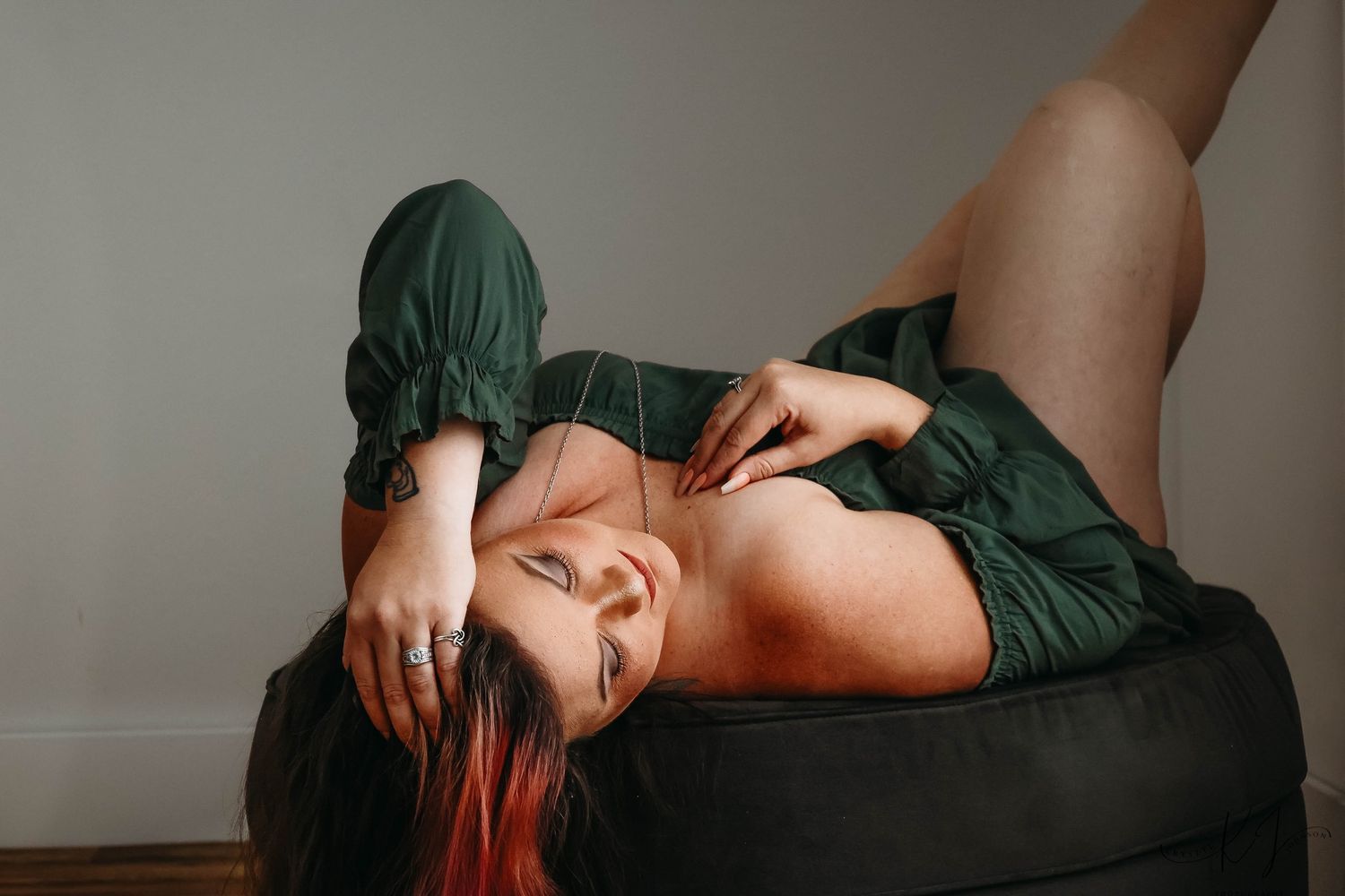 Sequence of artistic boudoir photos showing figure in red lingerie posing on wooden floor against dark wall.