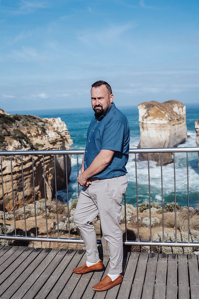 Scenic coastal viewpoint with rugged limestone cliffs and crashing waves along the Great Ocean Road in Australia.