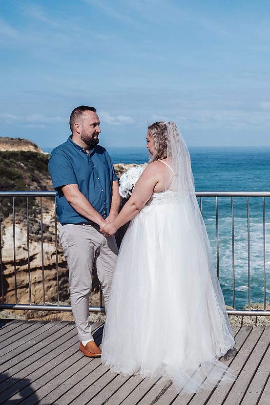Scenic coastal wedding photography sequence showing couple on wooden boardwalk overlooking ocean waves and cliffs.