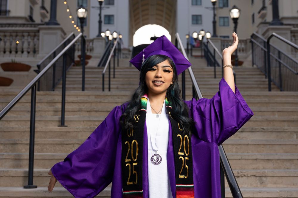 Graduation series showing a student in purple regalia and white dress raising hands in celebration on stone steps.