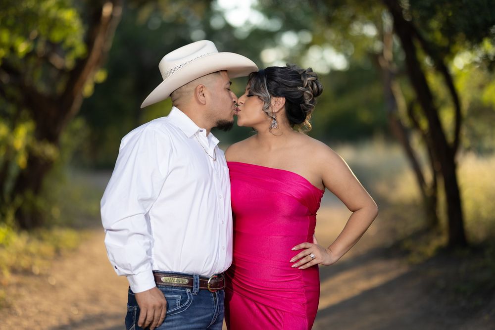 A romantic golden hour photoshoot captures intimate moments between a couple in western attire outdoors.