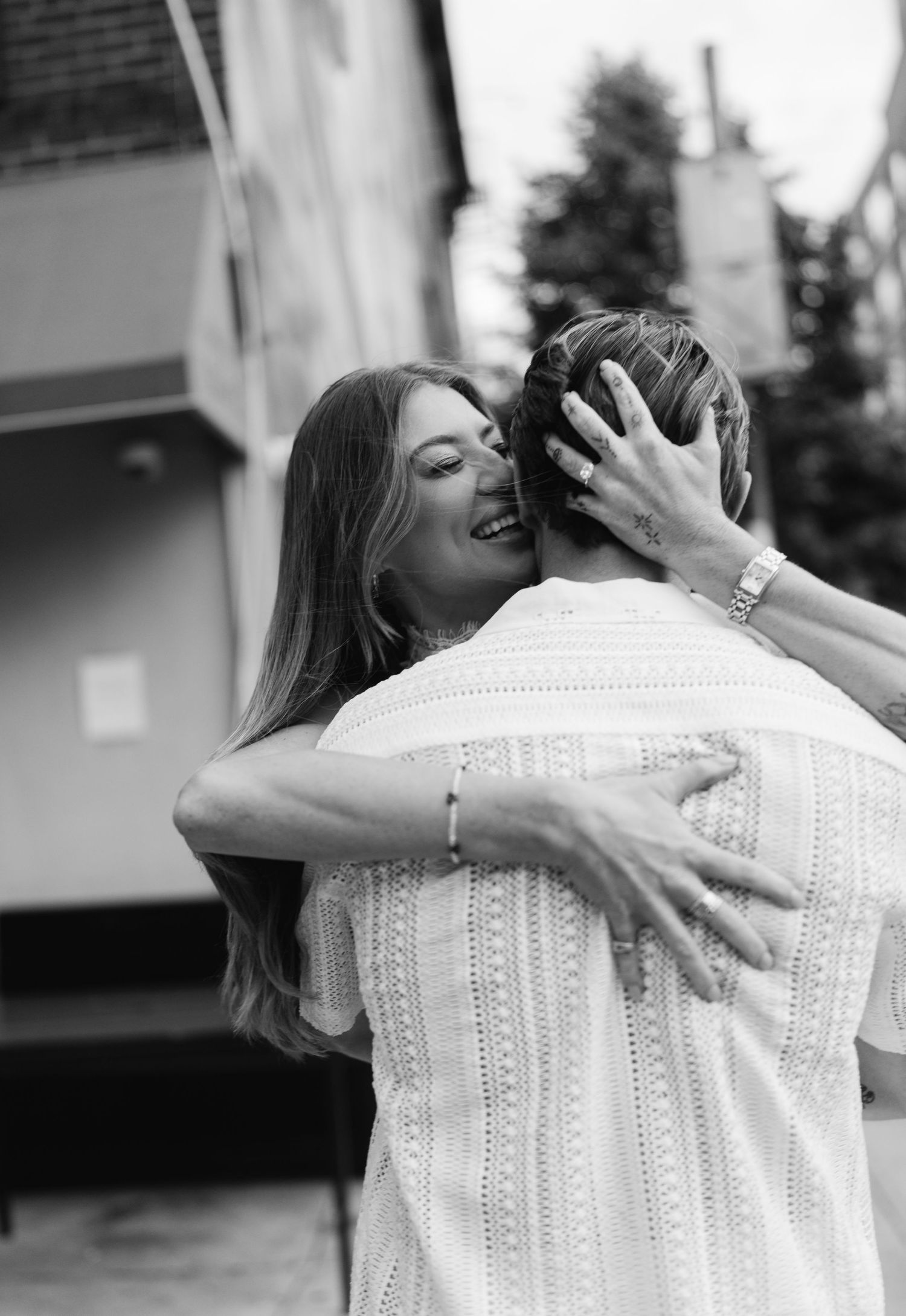 Black and white sequence showing an emotional embrace between two people.