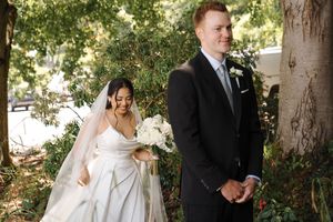 Wedding ceremony moments captured in a lush garden setting with natural sunlight filtering through trees.