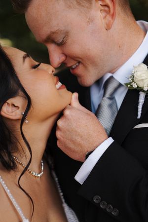 Romantic series of close-up wedding kiss photos with bride wearing delicate necklace and groom in formal attire.