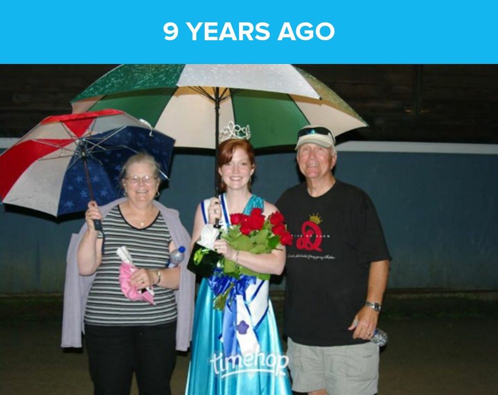 Group of people holding colorful umbrellas at a nighttime gathering.