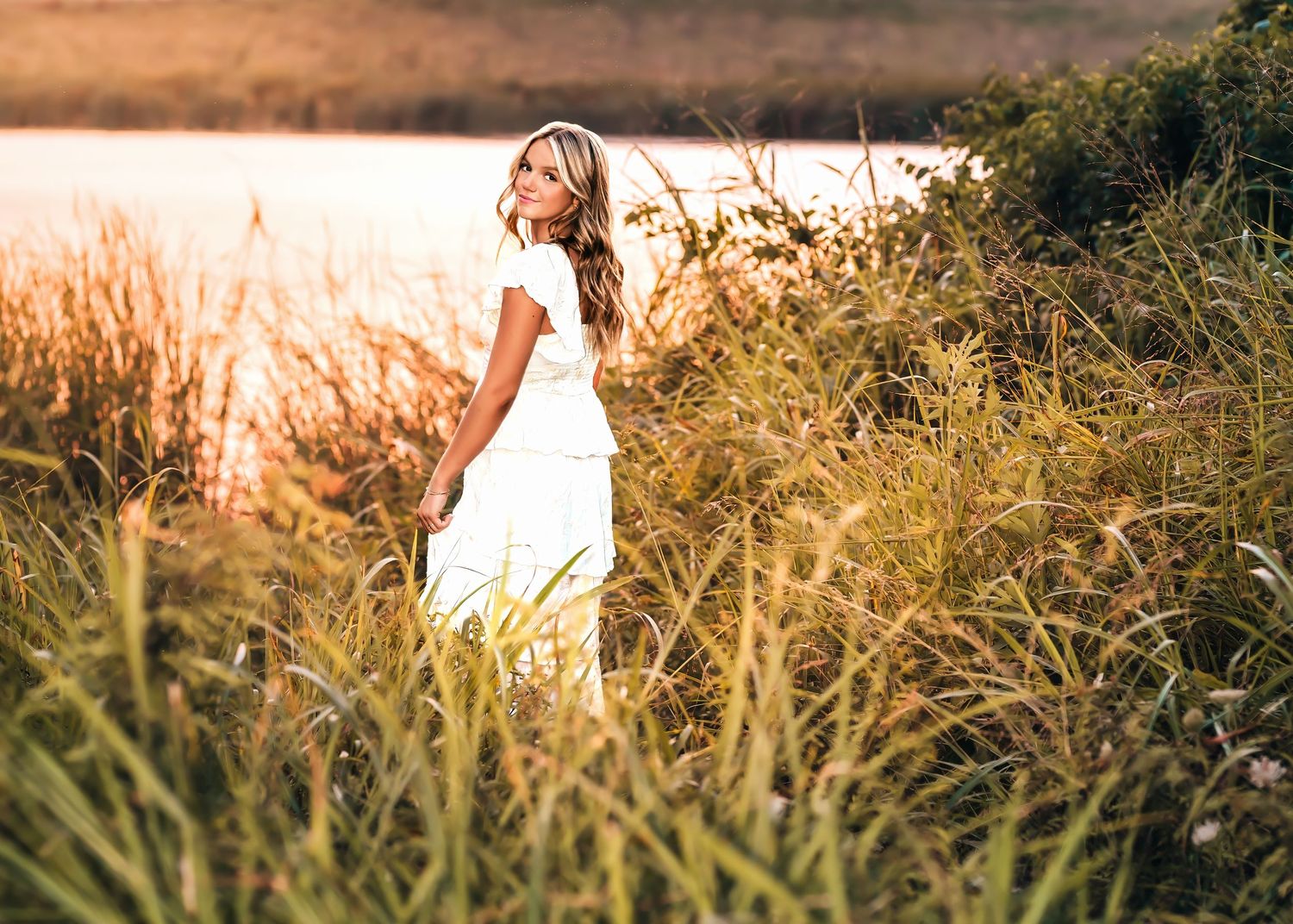 senior photo session in a field at sunset in mckinney tx