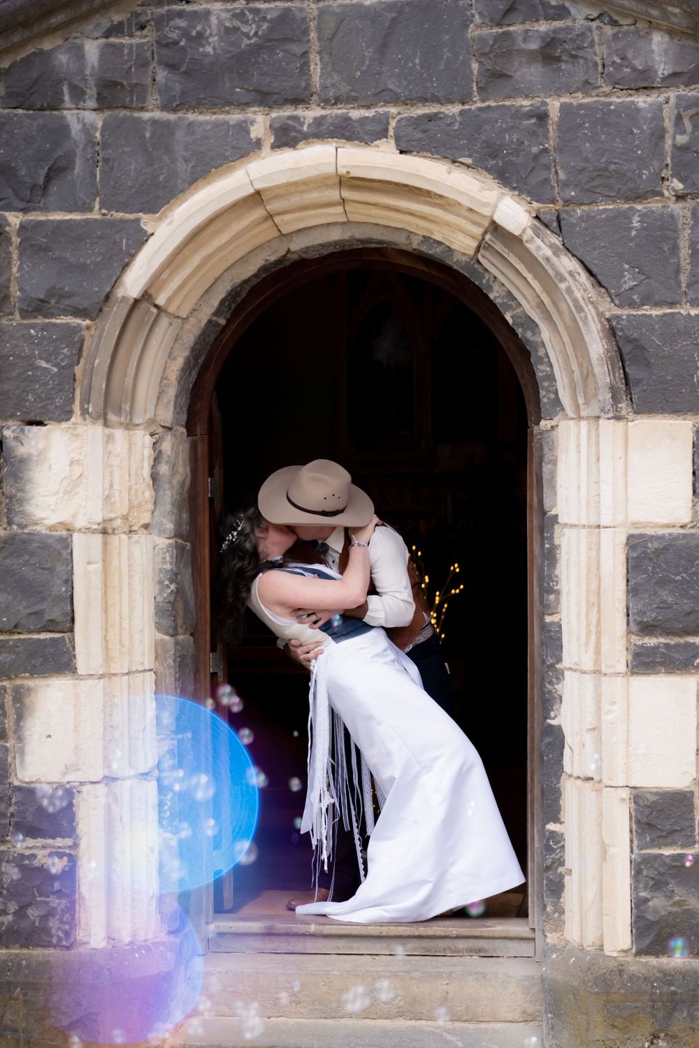 A sequence of stone archway frames showing a couple at a castle or historic building sharing a romantic moment together.