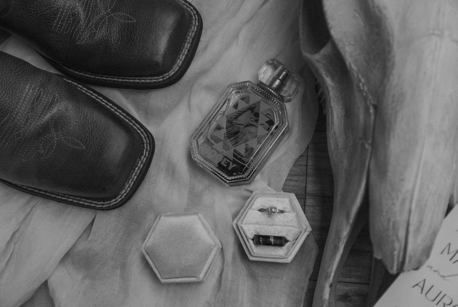 Detailed close-up shot of a black leather loafer shoe with Gucci logo being polished by a shoe shining brush.