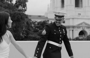 Black and white photo series showing joyful dance moves in sequence against an architectural backdrop.