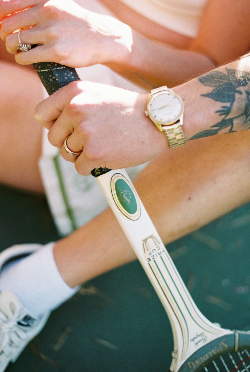 Several images showing a tattoo stencil being transferred onto someone's arm with blue transfer paper and a white razor.