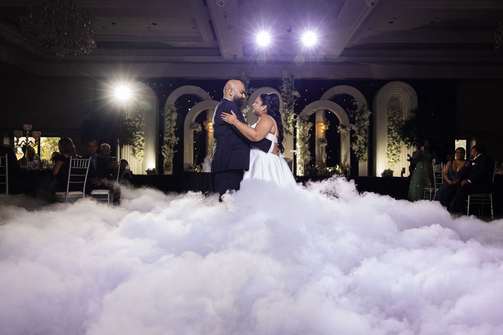 A foam party at a nightclub shows bubbles and foam filling the dance floor while bright lights illuminate the space.