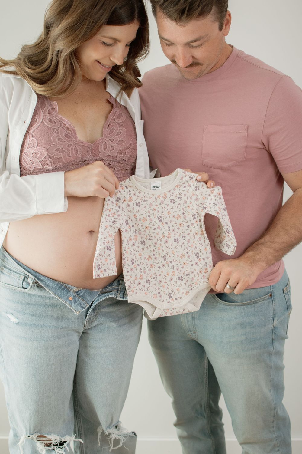 A couple in pink tops and jeans embraces, showing intimacy and connection in a sequence of casual lifestyle photos.