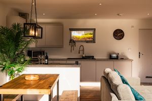 Modern coastal home interior features white walls, butcher block countertops, and natural elements throughout the space.