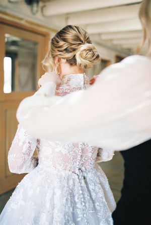 Elegant lace wedding dress with long sleeves captured in flowing motion during a bridal portrait session.