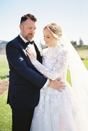 A romantic wedding photo shoot in an outdoor setting with sunlit scenery.