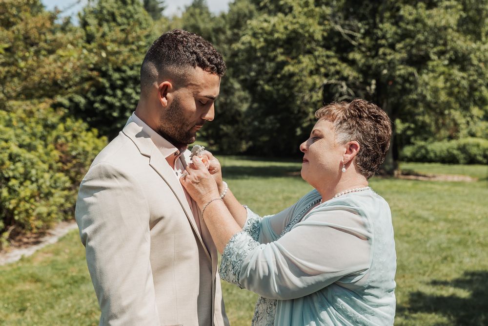 Two people practicing martial arts self defense moves outdoors in a sunny park setting.