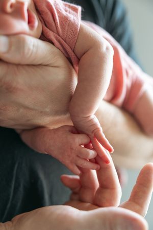 Close-up sequence of hands performing reflexology massage techniques on palm and fingers.