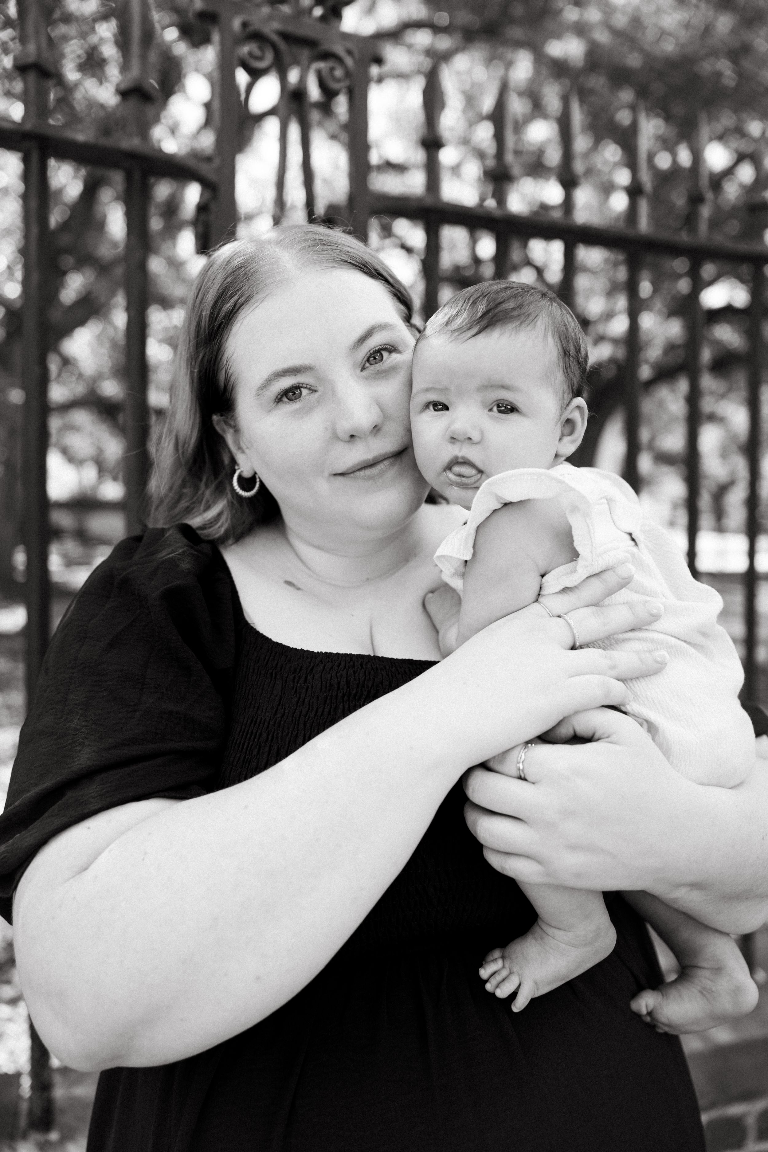 A black and white photo sequence shows a parent in dark clothing holding and interacting with a small baby.