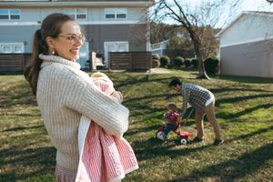 A sequence of outdoor family photos taken in a sunny backyard with toys scattered on the grass.