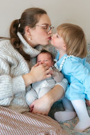 Tender moments shared between loved ones on a patterned blanket.