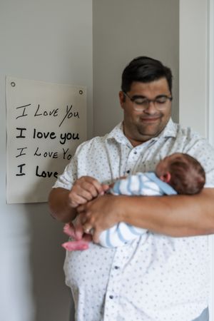 A series of photos showing a person in a white polka dot shirt writing 'I Love You' on a wall.