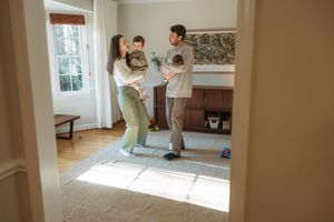 A tender family moment shared in a bright, airy room with hardwood floors and natural light.