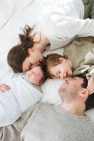 A series of intimate lifestyle photos showing relaxed moments lying down on white bedding.