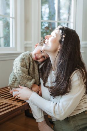 A series of candid lifestyle photos showing playful expressions and laughter in a bright indoor setting.