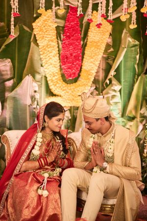 Wedding celebration scene with guests dressed in vibrant outfits, enjoying the festivities under decorative lights.