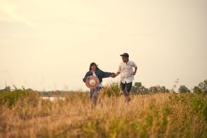 A couple standing close under surrounded in a romantic and intimate moment.