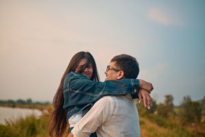 A couple standing close under surrounded in a romantic and intimate moment.