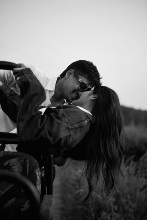 A couple standing close under surrounded in a romantic and intimate moment.