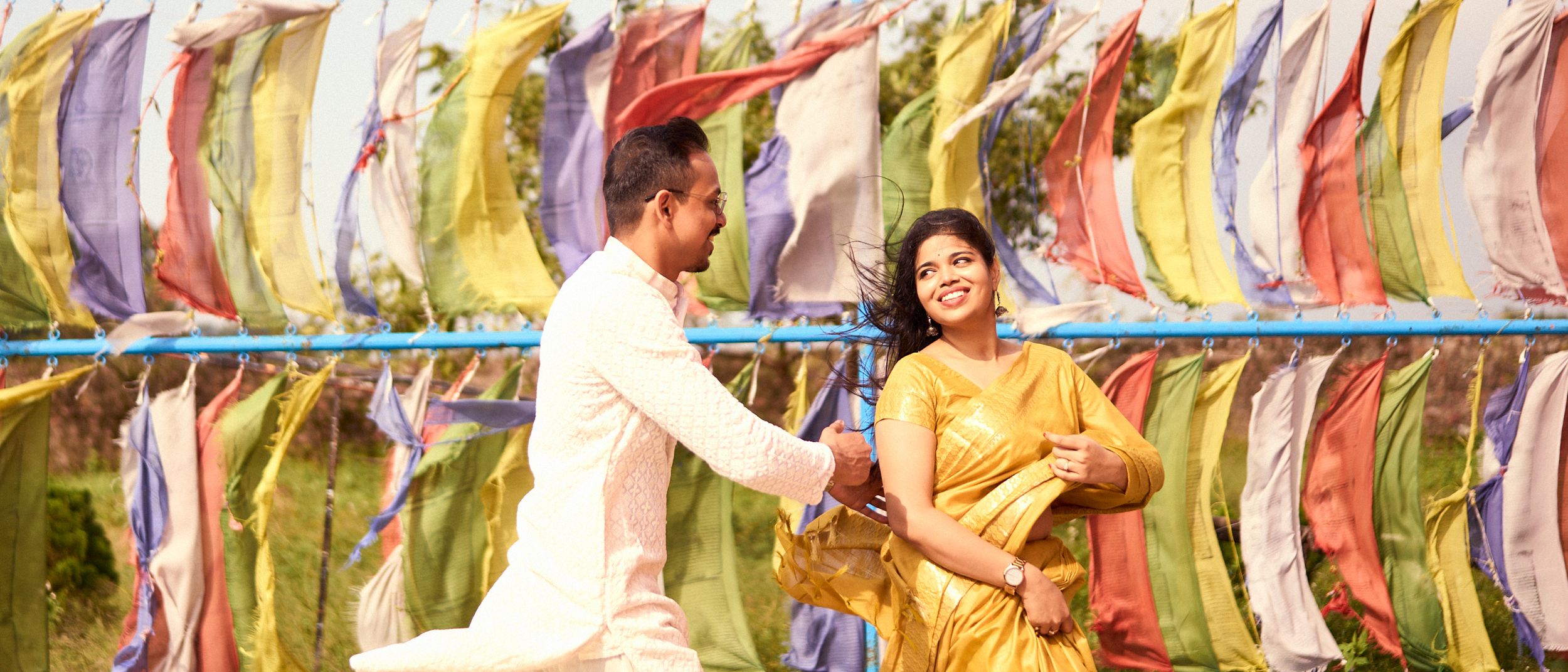 A couple standing close under surrounded in a romantic and intimate moment.