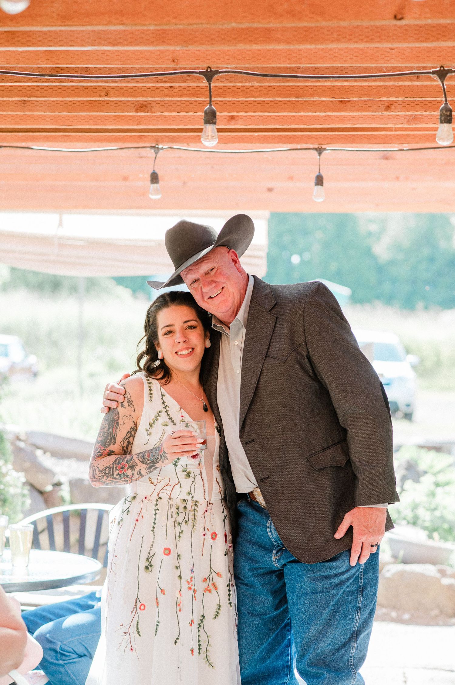 a bride hugs her father during wedding reception