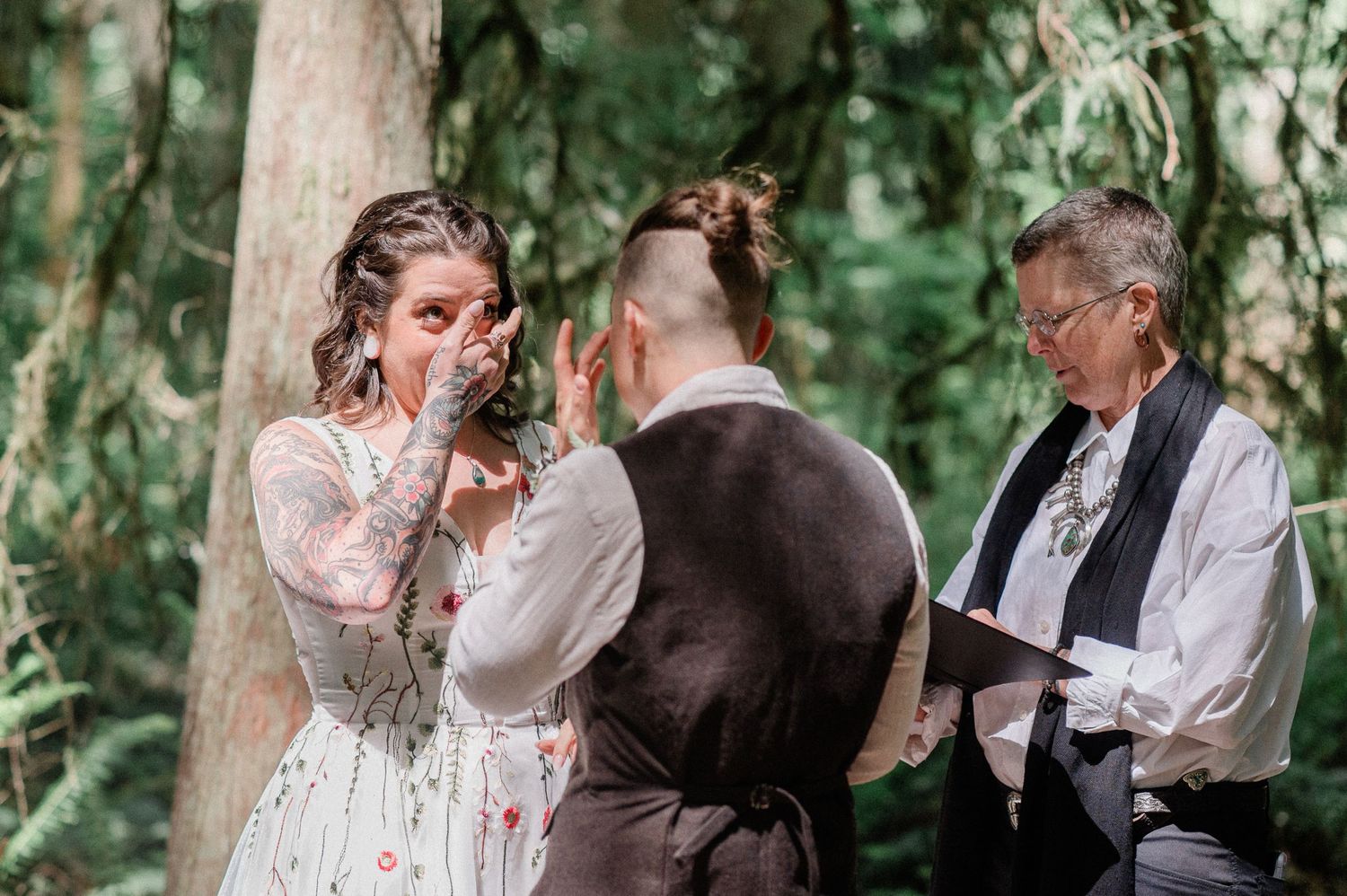 two brides crying during ceremony