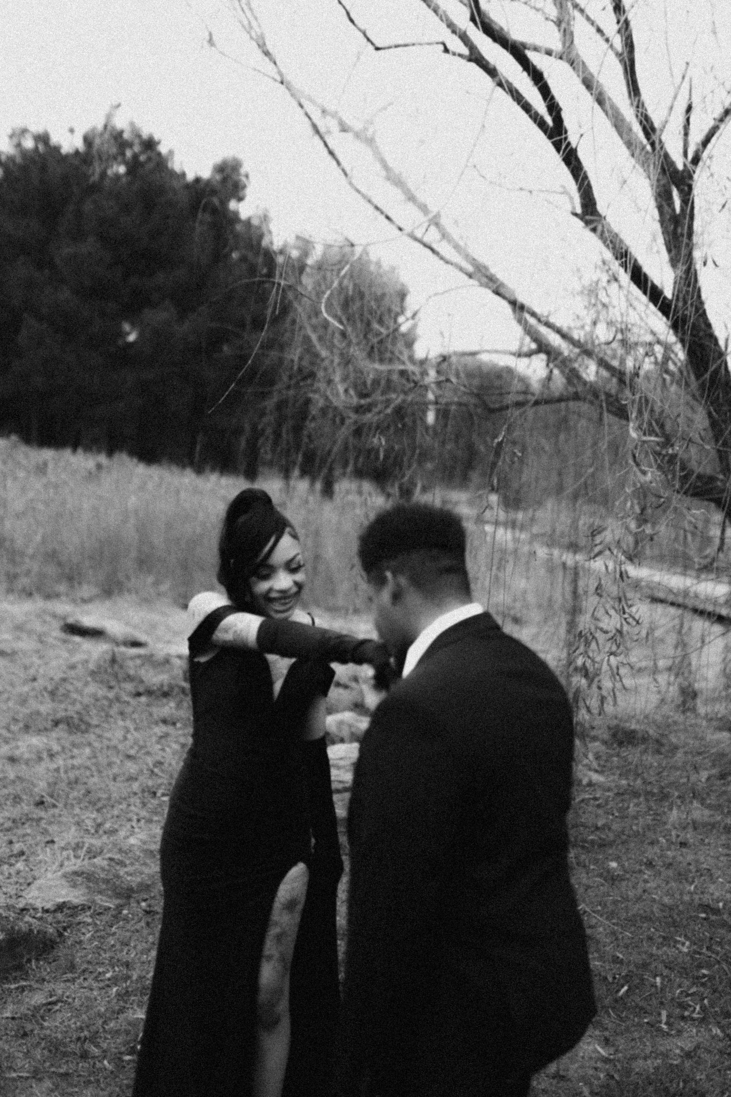 Artistic black and white photo series showing figures in formal attire in a natural outdoor setting.