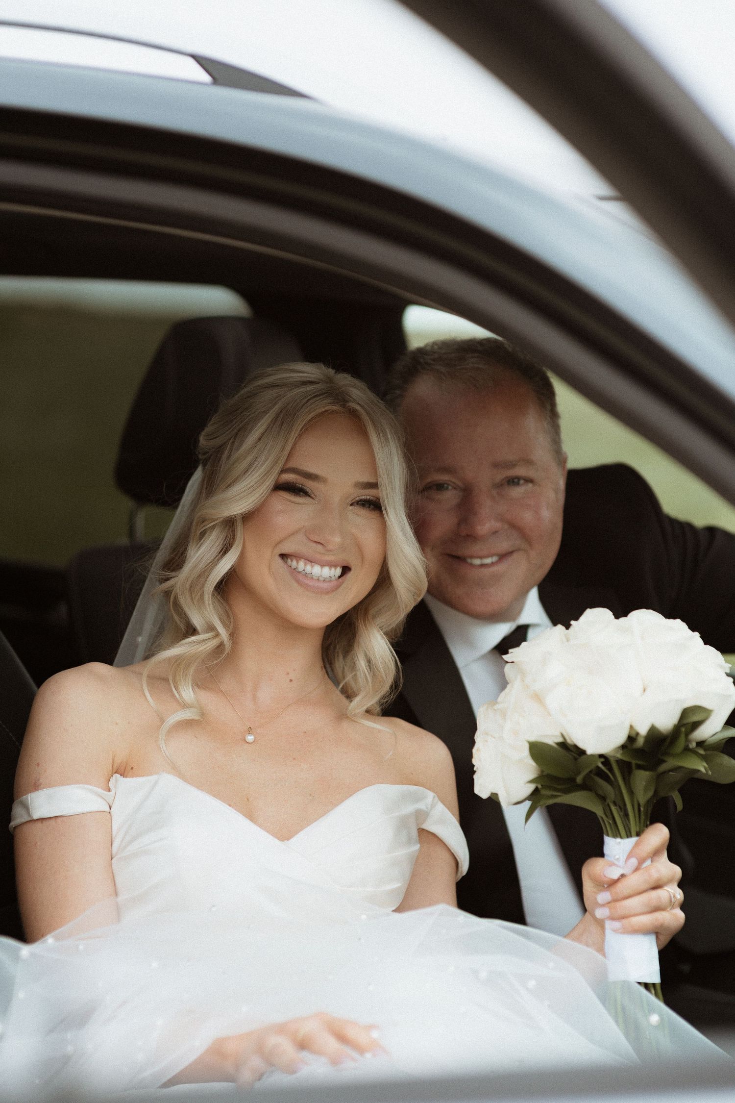 Bride with her father in the car