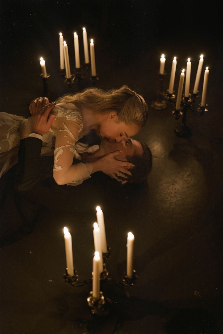 Artistic candlelit photography sequence featuring intimate poses in a dark moody setting.