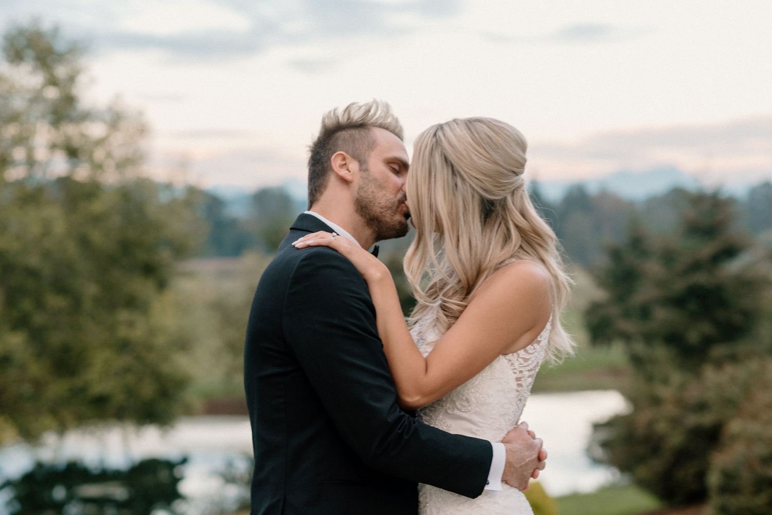 Elegant wedding couple portraits against scenic mountain landscape.
