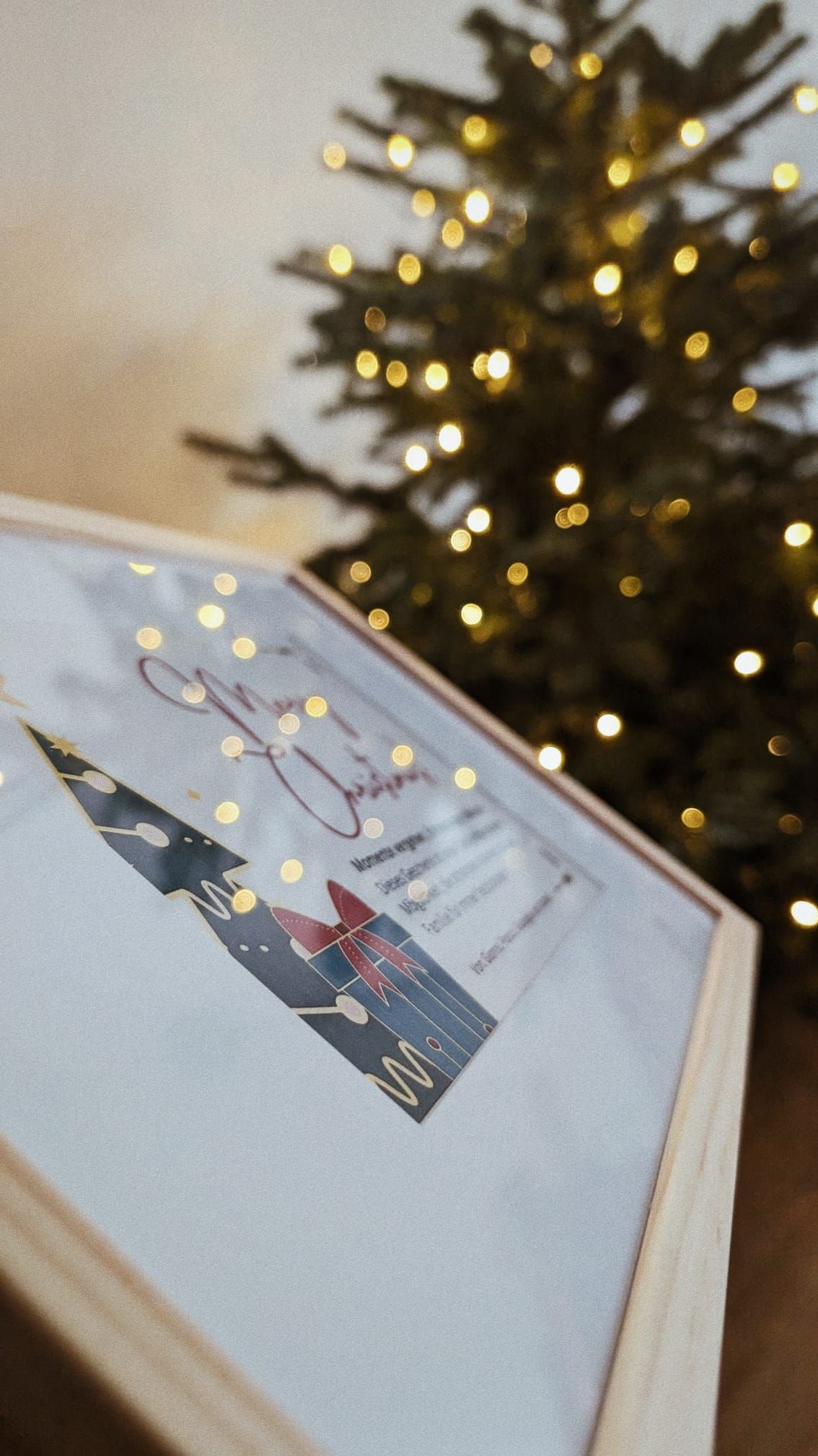 Artistic photos of Christmas cards with bokeh lights from tree in background.