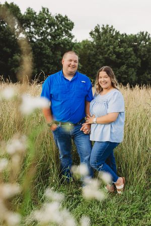 couple blue shirts in field of wildflowers and grass