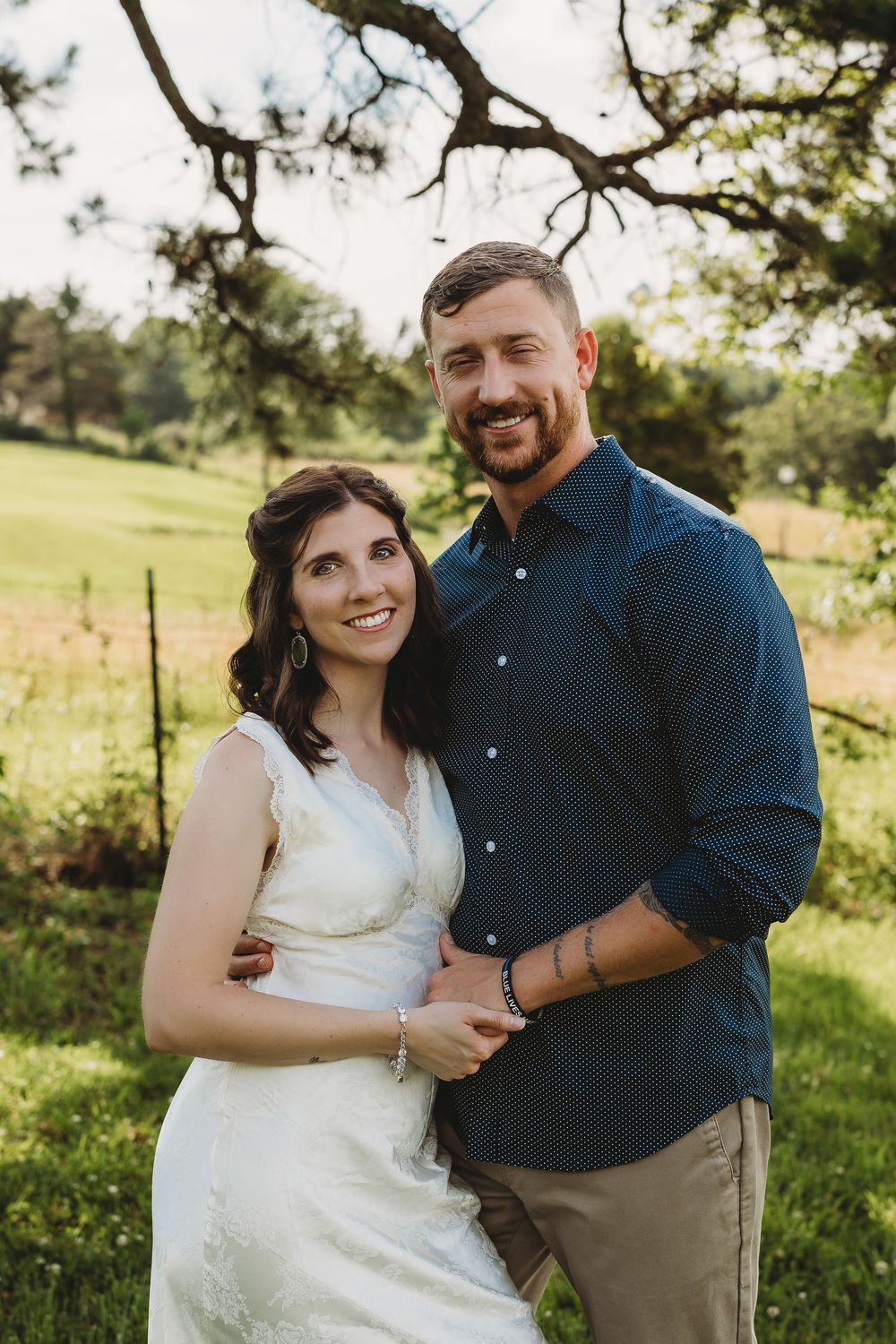 couple husband and wife white dress blue shirt khakis holding hands anniversary