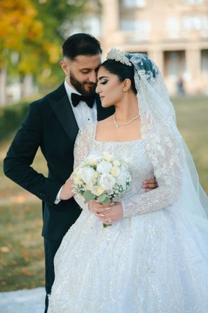Romantic autumn wedding portrait with classic white ball gown and black tuxedo.