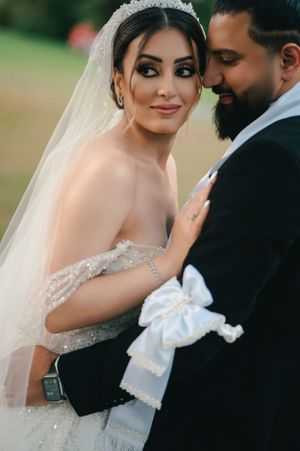 Romantic wedding portrait showing intricate details of bridal gown and veil.